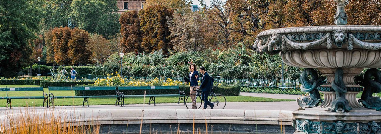 Man and Woman are walking through a park in Vienna